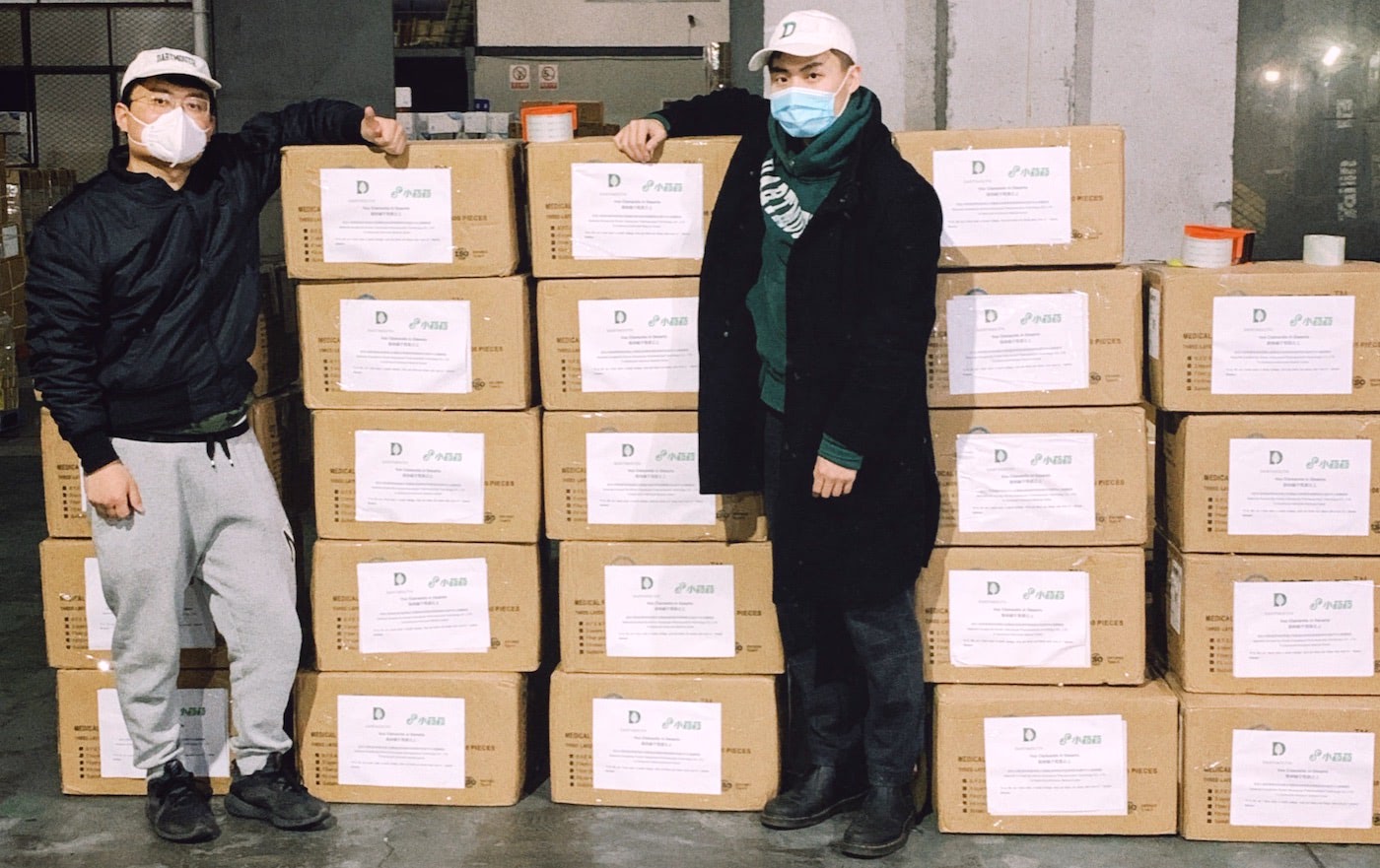 Dingyang Lu ’17 and Junfei Yu Th'19 stand with the boxes of masks